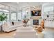 Cozy living area featuring a stone fireplace and built-in shelves at 603 Old Peachtree Ne Rd, Lawrenceville, GA 30043