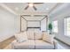 Spacious main bedroom showcasing a sitting area and a stylish canopy bed at 603 Old Peachtree Ne Rd, Lawrenceville, GA 30043