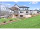 Expansive brick home with covered patio, outdoor stairs, and professionally landscaped yard at 603 Old Peachtree Ne Rd, Lawrenceville, GA 30043