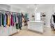 Spacious walk-in closet with custom shelves, drawers, and a center island at 603 Old Peachtree Ne Rd, Lawrenceville, GA 30043