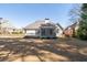 Wide backyard showcasing a screened porch, deck, and well-maintained lawn, ideal for relaxation and entertainment at 725 First Cotton Dr, Powder Springs, GA 30127