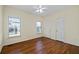 Bedroom with wood floors, ceiling fan, and two windows at 725 First Cotton Dr, Powder Springs, GA 30127