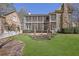 Large backyard featuring a well-maintained lawn, mature trees, and the rear of the house at 1421 Hedgewood Nw Ln, Kennesaw, GA 30152