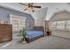 Cozy bedroom with carpeted floor, ceiling fan and plenty of natural light from two windows at 1421 Hedgewood Nw Ln, Kennesaw, GA 30152