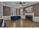 Cozy living room featuring hardwood floors, a fireplace, large windows, and a comfortable blue sofa at 1421 Hedgewood Nw Ln, Kennesaw, GA 30152