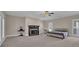 Spacious main bedroom with a fireplace, ceiling fan, and two windows providing natural light at 1421 Hedgewood Nw Ln, Kennesaw, GA 30152
