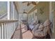 Inviting screened porch with comfortable seating, ceiling fans, and wooded views for outdoor relaxation at 1421 Hedgewood Nw Ln, Kennesaw, GA 30152