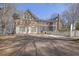 Spacious home featuring a stone exterior, a screened porch, a basketball area, and a long driveway at 1421 Hedgewood Nw Ln, Kennesaw, GA 30152