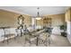 Elegant dining room with modern chandelier and glass table at 2613 Travois Sw Way, Lilburn, GA 30047