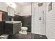 Bathroom featuring a dark vanity and a glass enclosed shower with white subway tile at 3060 Pharr Court North Nw # 619, Atlanta, GA 30305