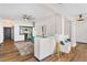 Open living space with view to kitchen and cozy armchairs, hardwood floors at 3060 Pharr Court North Nw # 619, Atlanta, GA 30305