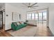 Bright living room boasts a green sofa, city views, large windows, and modern decor at 3060 Pharr Court North Nw # 619, Atlanta, GA 30305