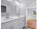 A bright bathroom with double vanity, white cabinets, and modern fixtures at 3200 Tackett Rd, Douglasville, GA 30135