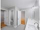 Bathroom with double sinks, tile floor, and water closet in neutral colors at 3200 Tackett Rd, Douglasville, GA 30135