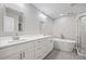 Modern bathroom featuring dual sinks, white cabinets, soaker tub and glass enclosed shower at 3200 Tackett Rd, Douglasville, GA 30135