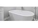 Bathroom featuring a white soaker tub and glass enclosed shower with shower head at 3200 Tackett Rd, Douglasville, GA 30135