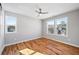 A spacious bedroom with gleaming hardwood floors and natural light from three windows at 3200 Tackett Rd, Douglasville, GA 30135