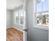 A sunlit bedroom with hardwood floors, with neighborhood views from the many windows at 3200 Tackett Rd, Douglasville, GA 30135