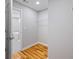 Bright closet leads to modern bathroom with a white soaking tub and tile flooring at 3200 Tackett Rd, Douglasville, GA 30135