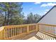 New wood deck with wood railing looks out over a green and dense backyard landscape at 3200 Tackett Rd, Douglasville, GA 30135