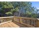 A wooden deck showcases scenic views of the lush trees and greenery surrounding the property at 3200 Tackett Rd, Douglasville, GA 30135
