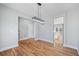 Bright dining room with hardwood floors featuring a modern light fixture at 3200 Tackett Rd, Douglasville, GA 30135