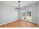 Bright dining room featuring hardwood floors and a modern light fixture at 3200 Tackett Rd, Douglasville, GA 30135