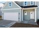 Close up of a charming two-story home with a two car garage and attractive siding at 3200 Tackett Rd, Douglasville, GA 30135