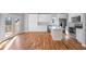 Bright eat-in kitchen featuring white cabinets, stainless appliances, hardwood floors, and large island with quartz countertops at 3200 Tackett Rd, Douglasville, GA 30135