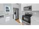 Kitchen features stainless steel appliances, white cabinets, quartz countertops, and modern fixtures at 3200 Tackett Rd, Douglasville, GA 30135