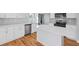 Kitchen features stainless steel appliances, white cabinets, quartz countertops, and modern fixtures at 3200 Tackett Rd, Douglasville, GA 30135