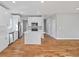 Bright eat-in kitchen featuring white cabinets, stainless appliances, hardwood floors, and large island at 3200 Tackett Rd, Douglasville, GA 30135