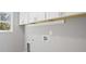 Neutral laundry room features white cabinets and access for washer and dryer at 3200 Tackett Rd, Douglasville, GA 30135