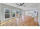 Spacious living room boasts hardwood floors, many windows and an open kitchen at 3200 Tackett Rd, Douglasville, GA 30135