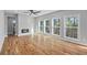 Spacious living room with modern fireplace, hardwood floors, and large windows providing ample natural light at 3200 Tackett Rd, Douglasville, GA 30135