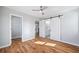 A well-lit bedroom featuring gleaming hardwood floors and ensuite bathroom access at 3200 Tackett Rd, Douglasville, GA 30135