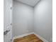 A room with hardwood floors and gray walls features a white door and trim at 3200 Tackett Rd, Douglasville, GA 30135