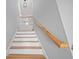 Staircase shows wood handrail, gray walls and white stairs with wood treads at 3200 Tackett Rd, Douglasville, GA 30135