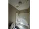 Bathroom featuring a white tile shower and tub with neutral paint color at 4707 Mariners Way, Stone Mountain, GA 30083