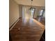 Dining room area featuring hardwood flooring, natural light, and an elegant light fixture at 4707 Mariners Way, Stone Mountain, GA 30083