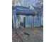 Exterior of home featuring a small gated yard space with damaged fence in need of repair at 4707 Mariners Way, Stone Mountain, GA 30083
