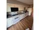 Kitchen with white appliances, cabinets and vinyl flooring at 4707 Mariners Way, Stone Mountain, GA 30083