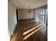 A bright living area with hardwood flooring and natural light, complemented by a simple light fixture at 4707 Mariners Way, Stone Mountain, GA 30083