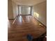 A large living room with hardwood floors and bright natural light throughout the space at 4707 Mariners Way, Stone Mountain, GA 30083