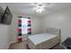 Cozy bedroom with neutral tones, a ceiling fan, a large window, and a desk at 1399 Windy Ridge Se Ct, Conyers, GA 30013