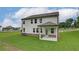 Backyard view of the home featuring a covered patio and a well-maintained lawn at 1856 Kingsmere Run Dr, Loganville, GA 30052