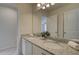 Bathroom featuring a double granite vanity and a large mirror, creating a luxurious and functional space at 1856 Kingsmere Run Dr, Loganville, GA 30052