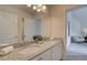 Bathroom featuring a double granite vanity and a large mirror, creating a luxurious and functional space at 1856 Kingsmere Run Dr, Loganville, GA 30052