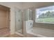 Modern bathroom featuring a separate tub and glass enclosed shower at 1856 Kingsmere Run Dr, Loganville, GA 30052