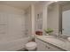 Clean bathroom with a shower-tub combo, granite countertop, and white cabinetry at 1856 Kingsmere Run Dr, Loganville, GA 30052